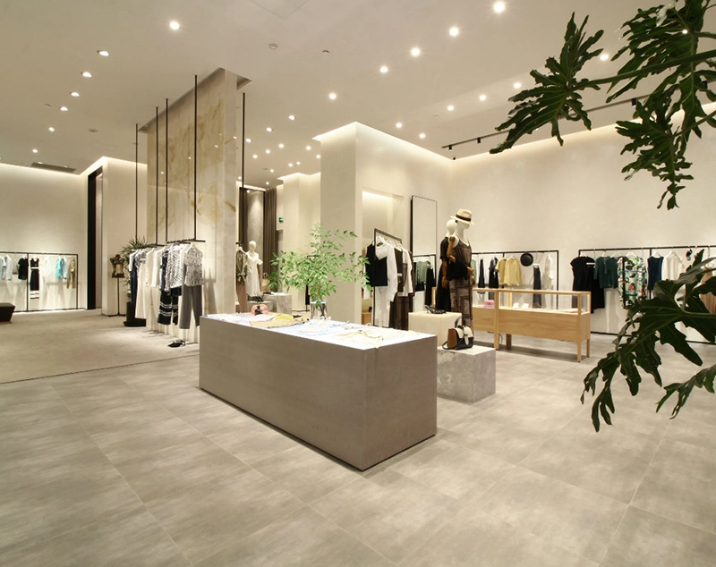 ONI Display Bright Minimalist Boutique Space: White Canvas Featuring Central Marble Reception Desks